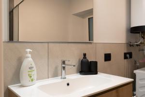 a bathroom sink with a bottle of soap on it at NEW Tocai – in via Rastello per 4 pp in Gorizia +14 photos