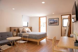 a bedroom with a bed and a living room at Patio 7 Studios in San Miguel de Allende