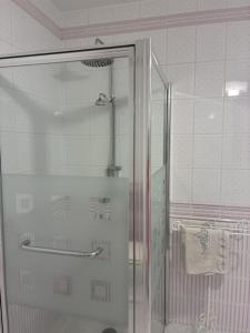 a shower with a glass door in a bathroom at Les 4 saisons in Menneville