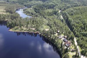 an aerial view of a house on an island in a lake at Nya Skogsgården Hostel in Torsby
