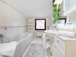 a white bathroom with a tub and a sink at Casa di Iaio - Wi-Fi Netflix Home Cinema in Gorizia