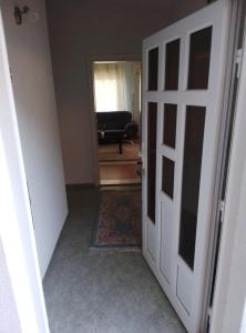 an open door to a living room with a chair at 3 Zimmer Wohnung in Sutomore