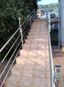a set of stairs leading up to a house at 3 Zimmer Wohnung in Sutomore +5 photos