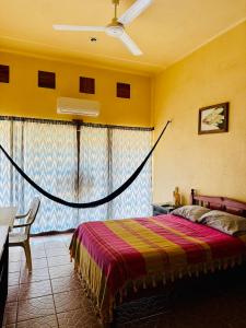 a bedroom with a bed with a net around it at Casa Colibri La Punta in Brisas de Zicatela