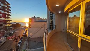 a balcony of a building with a view of a city at Viento Sur Anfitrionas "Centro" in Puerto Madryn
