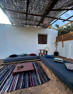 a room with a bed and a table on a rug at Moroohouse in Dahab