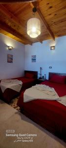 a bedroom with two beds and a ceiling at Moroohouse in Dahab