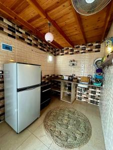 a kitchen with a stainless steel refrigerator and a rug at Moroohouse in Dahab
