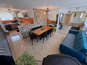 a living room with a blue couch and a table at Casuta din Crang in Moieciu de Jos