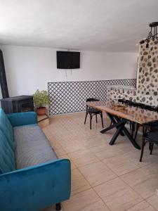 a living room with a couch and a table at Casuta din Crang in Moieciu de Jos