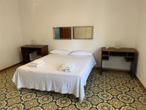 a bedroom with a bed with two tables and a mirror at Vista Mare a 300 mt dalla spiaggia in Cariati