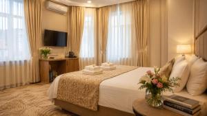 a hotel room with a bed and a television at Premier Hotel in Baku