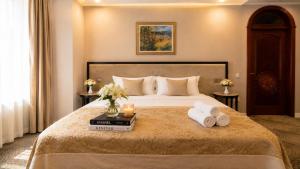 a hotel room with a bed with towels on it at Premier Hotel in Baku +52 photos
