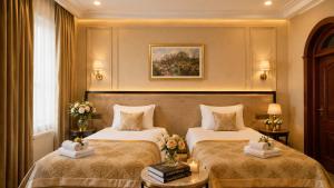 a hotel room with two beds with flowers on them at Premier Hotel in Baku