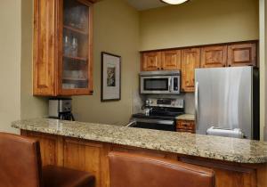 a kitchen with a refrigerator and a microwave at The Residences at Mountain Lodge by Hyatt Vacation Club in Beaver Creek