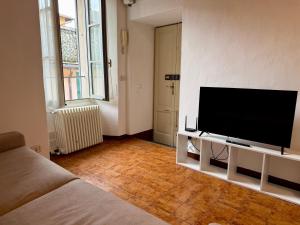 a living room with a flat screen tv on a wall at The Nest in Mandello del Lario
