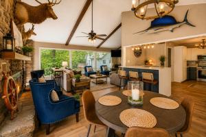 a kitchen and living room with a table and chairs at Pub, Hot Tub, Game Room, Monkey Island Waterfront in Afton