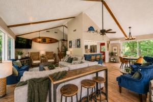 a living room with blue chairs and a couch at Pub, Hot Tub, Game Room, Monkey Island Waterfront in Afton