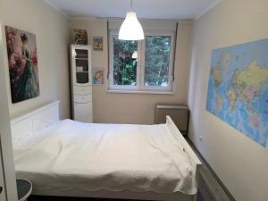 a bedroom with a bed and a map on the wall at Moj Mali Hotel in Valjevo