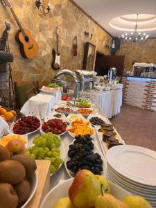 a buffet of fruits and vegetables on a table at Rambuje Resort in Lezhë