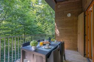 a table on the back porch of a house at Les Charmes C18 - Le Val Joly in Eppe-Sauvage +6 photos
