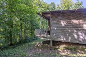 a cabin in the woods with a porch at Les Charmes C18 - Le Val Joly in Eppe-Sauvage