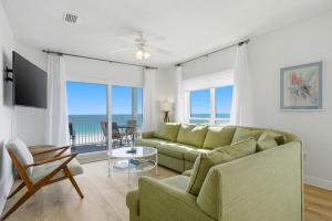 a living room with a couch and a view of the ocean at Riviera Dunes 503 in Perdido Key