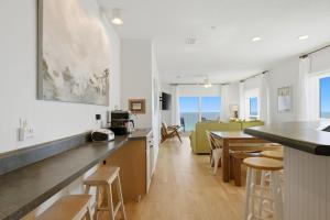a kitchen and living room with a table and chairs at Riviera Dunes 503 in Perdido Key