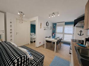 a kitchen and a living room with a table at La Rinascita HOUSE in Francavilla al Mare