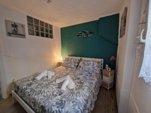 a bedroom with a bed with a green wall at La Rinascita HOUSE in Francavilla al Mare