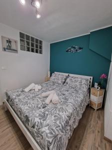 a bedroom with a large bed with blue walls at La Rinascita HOUSE in Francavilla al Mare