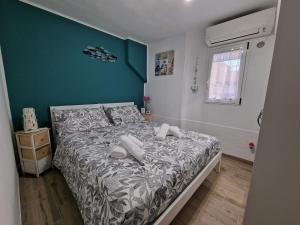 a bedroom with a bed and a green wall at La Rinascita HOUSE in Francavilla al Mare