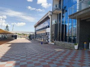 a building with a checkered sidewalk in front of it at The New Taiwan Hotel in Nyanhemwa