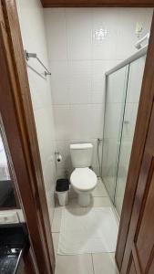 a bathroom with a toilet and a glass shower at Suítes Aymoré in Itacaré +10 photos