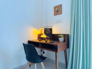 a desk with a laptop on it with a chair at Slow Life Coliving, Hiriketiya in Dickwella