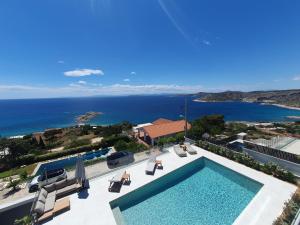 a swimming pool with a view of the ocean at Villa Erifyli in Aghia Marina