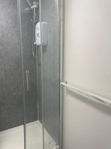 a shower with a glass door with a soap dispenser at Jayden house in Middlesbrough