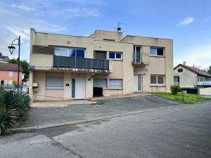 a building with a parking lot in front of it at Studio de l'étoile in Bavans