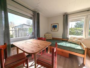 a dining room with a table and a window at Nordseehof Reitz in Friedrichskoog