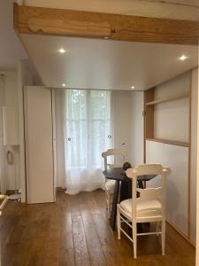 a dining room with a table and chairs and a window at Studio Disney Paris in Bailly-Romainvilliers