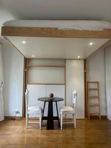 a room with a table and two chairs and a bed at Studio Disney Paris in Bailly-Romainvilliers +4 photos