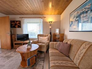 a living room with a couch and a table at Nordseehof Reitz in Friedrichskoog