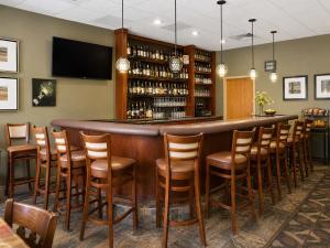 a bar in a restaurant with a bunch of chairs at Ocean Landings Resort Cocoa Beach Port Canaveral in Cocoa Beach +15 photos