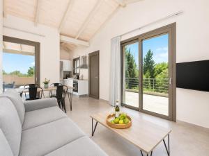 a living room with a couch and a table at Villa Gerasmia in Trapezaki