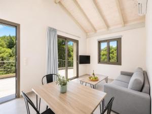 a living room with a table and a couch at Villa Gerasmia in Trapezaki