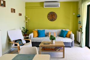 a living room with a couch and a table at Melrose maisonette by the sea in Anavissos in Anavyssos