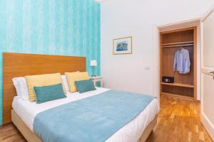 a bedroom with a large bed with blue walls at Maison Il Corso in Sorrento