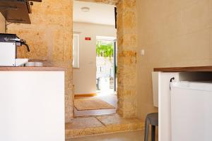 a kitchen with a doorway leading into a room with a hallway at SuCaSa Full house with terrace 5 min from centre in Coimbra