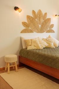 a bedroom with a bed with a plant on the wall at SuCaSa Full house with terrace 5 min from centre in Coimbra