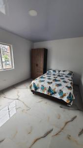 a bedroom with a bed and a marble floor at Pachamama House in Bucaramanga +6 photos